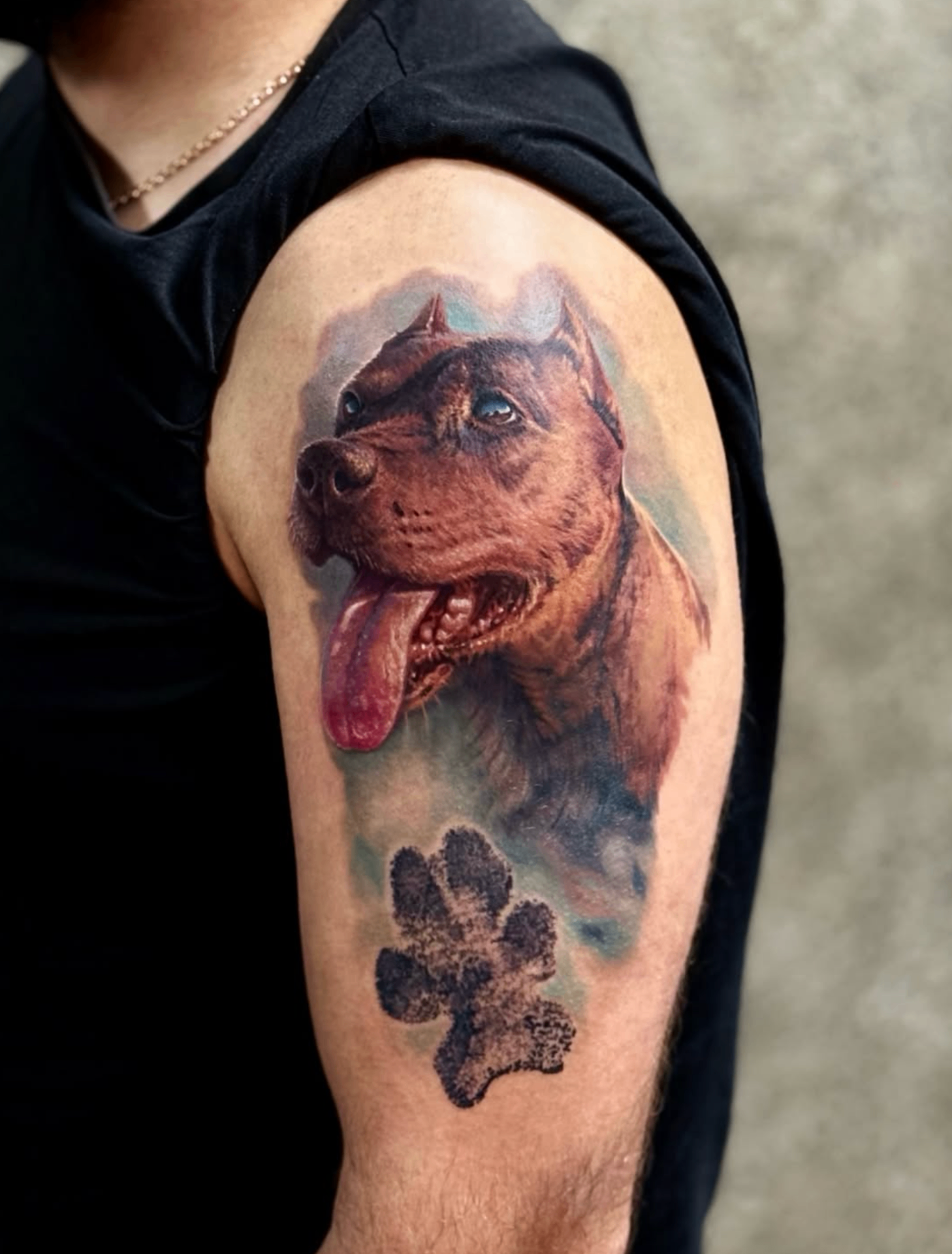 Realistic dog portrait tattoo on upper arm