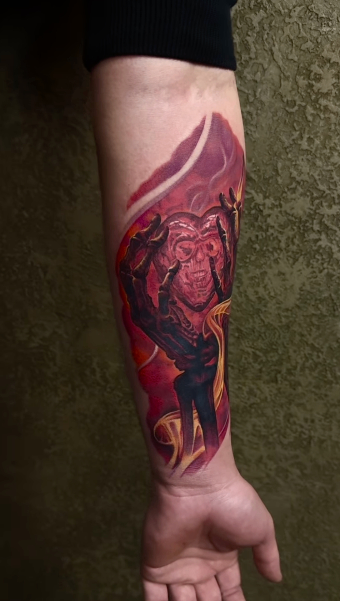 Red-toned tattoo with a stylized monkey skeleton motif